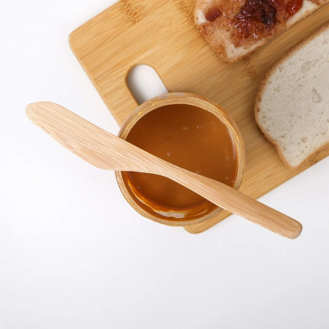 Sustainable wooden kitchen utensils and brushes on a white background, promoting eco-friendly living.